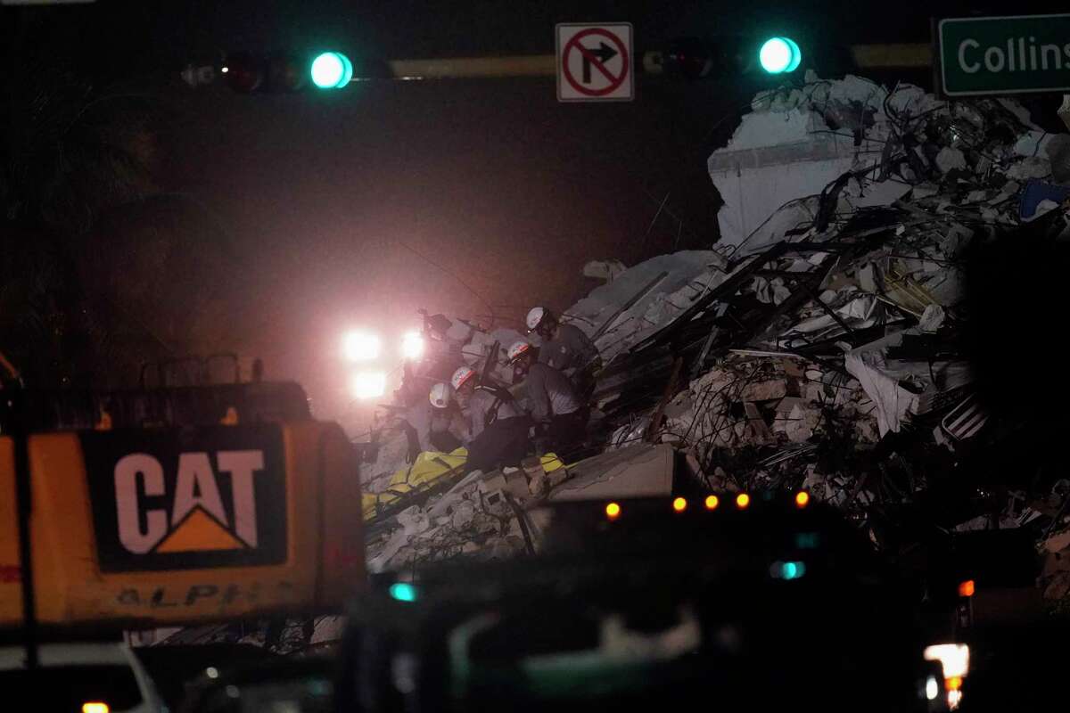 Rescue workers remove a body from the rubble where a wing of a 12-story beachfront condo building collapsed, Thursday, June 24, 2021, in the Surfside area of Miami.