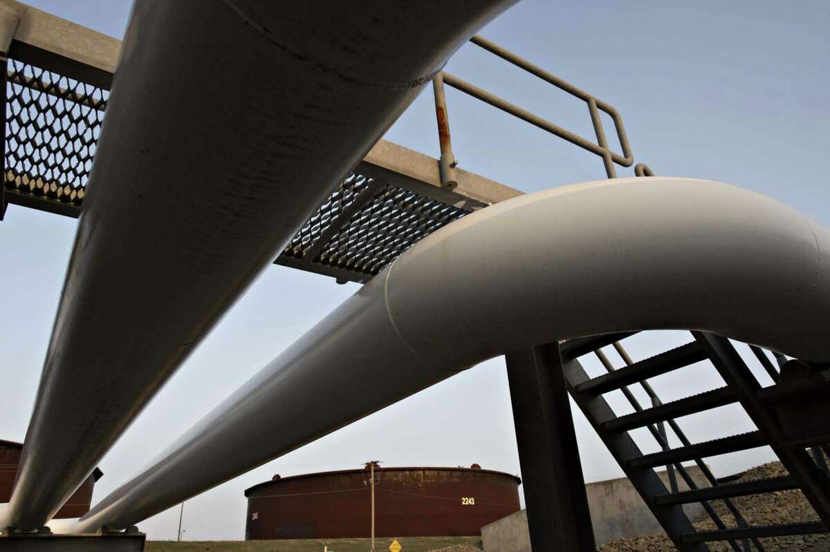 Pipelines run toward oil storage tanks in Cushing, Okla. Pipelines face a tougher regulatory terrain.