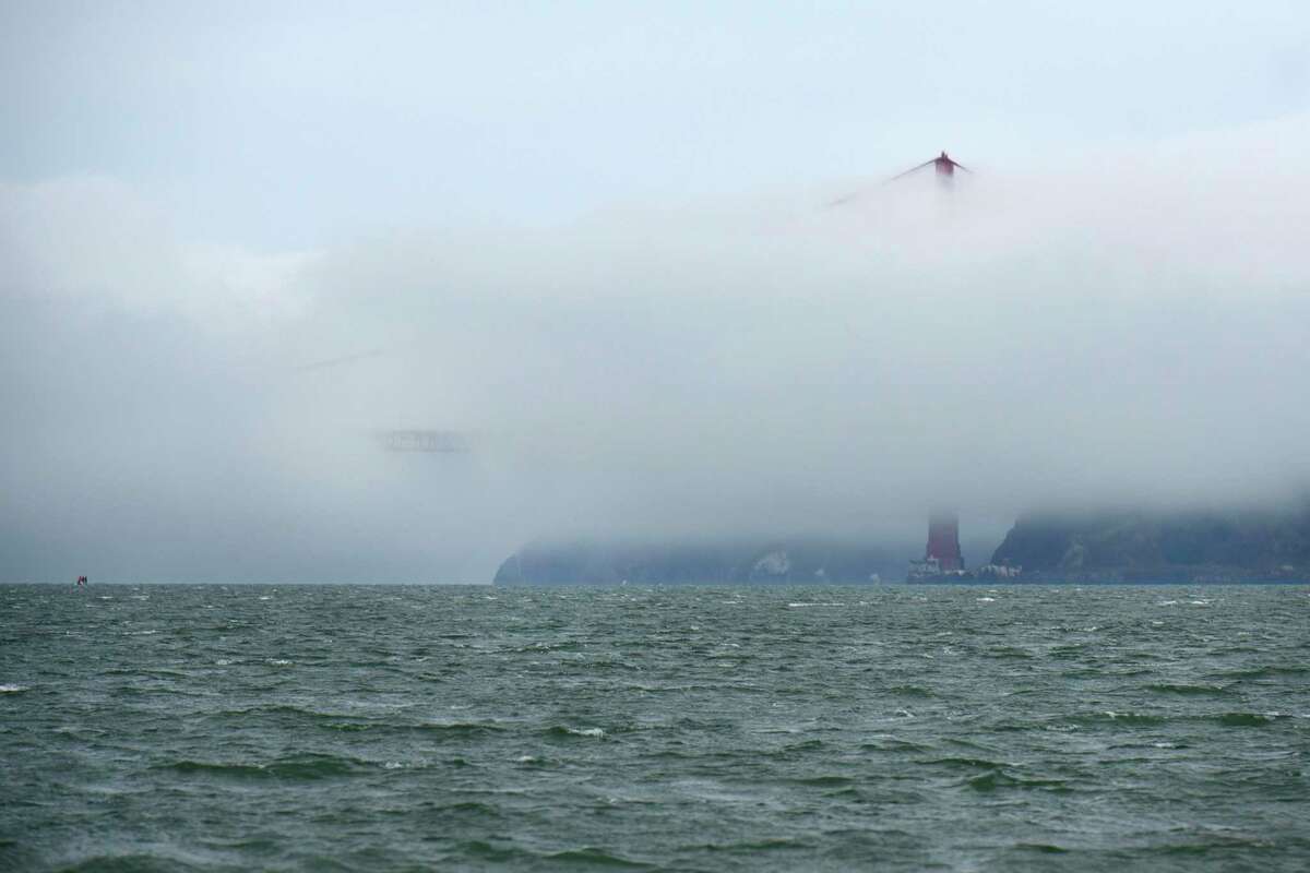 Fog obscures the Golden Gat Bridge as Steve Clark, of El Sobrante, fishes for halibut in San Francisco Bay on Saturday, June 4, 2016, in San Francisco, Calif.