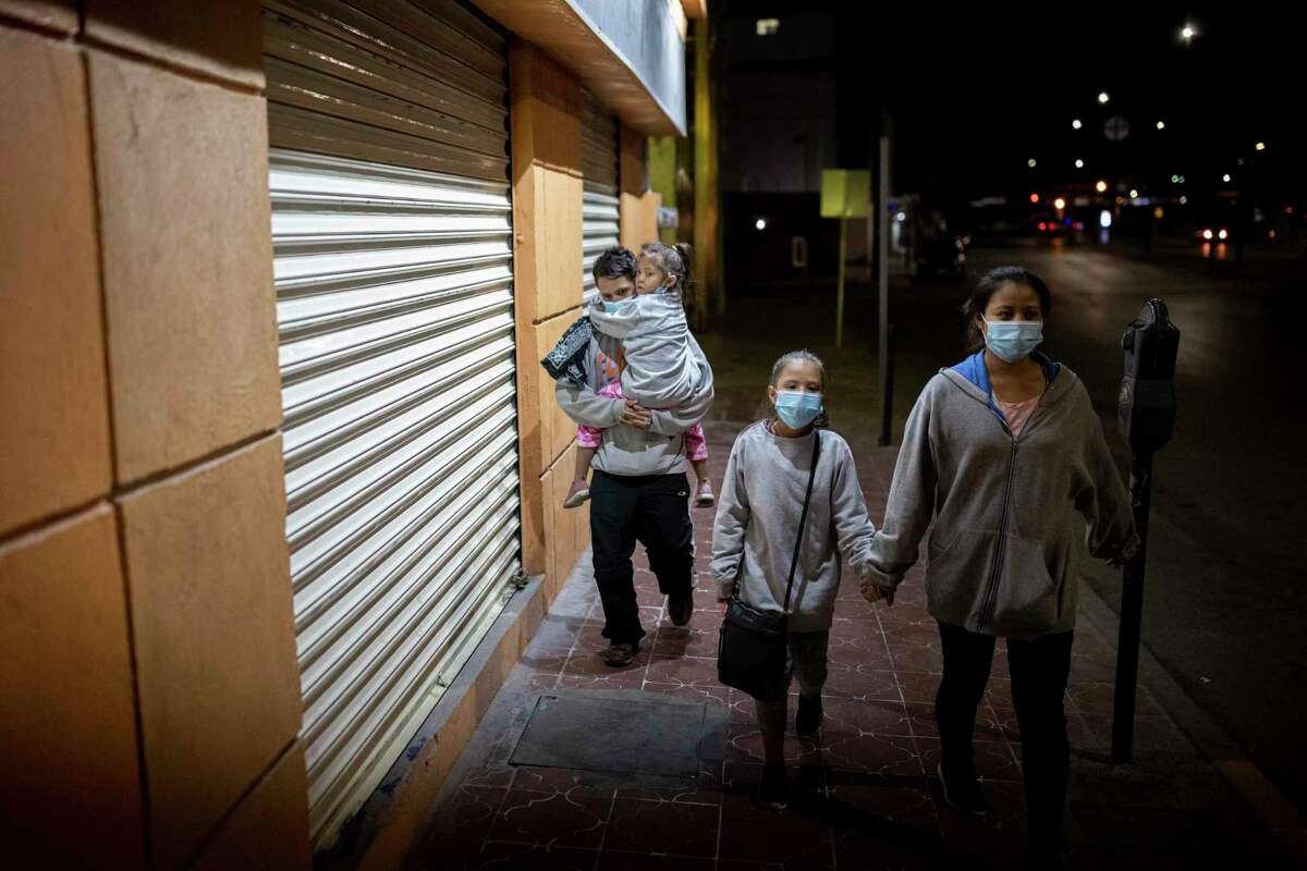 A husband and wife and their two daughters from Honduras walk through downtown Juarez moments after being deported from El Paso under Title 43 back into Mexico, Thursday, March 25, 2021, in Juarez, Mexico. Photo by Ivan Pierre Aguirre