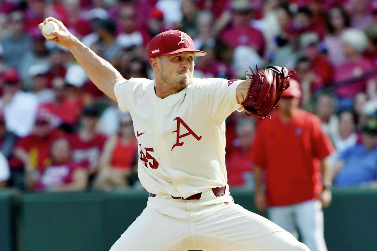 Arkansas pitcher Kevin Kopps (45) throws against North Carolina State in the second inning of an NCAA college baseball super regional game, Sunday, June 13, 2021, in Fayetteville, Ark. (AP Photo/Michael Woods)