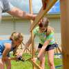 Lulu and her sister Sara Church help construct a new playset at Midland Eagles Aerie 2110 in May.