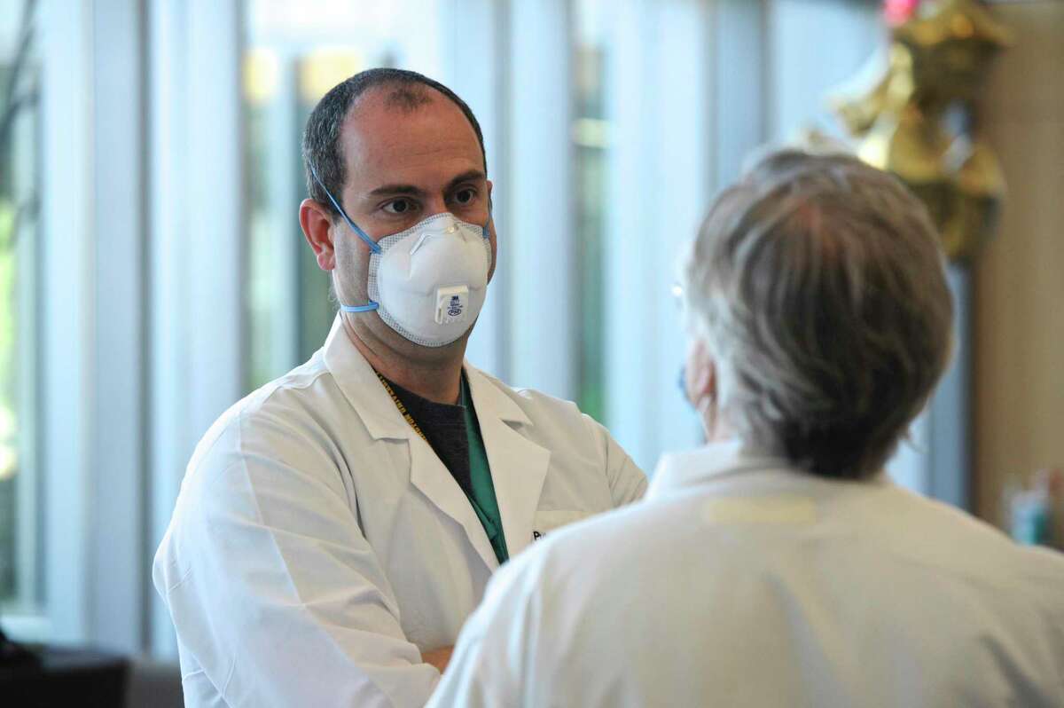 Dr. Guillermo Ballarino MD, Pulmonary/Critical Care, talks with Dr. Paul Nee MD, Infectious Disease. Both are members of the medical team that worked with Chris Tillett, the first Covid-19 patient in Connecticut. Tuesday, April 5, 2020, at Danbury Hospital, Danbury Conn.
