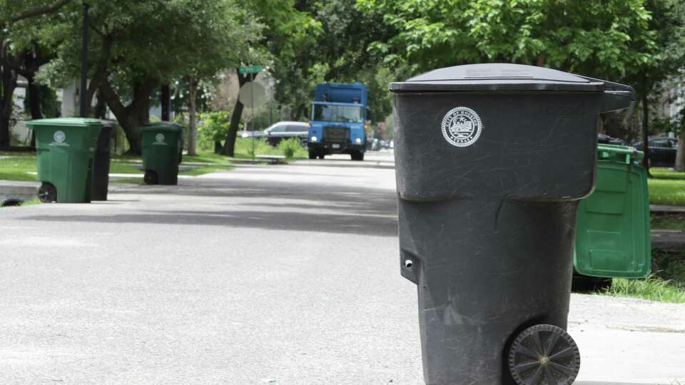 A city recycling truck makes its way down Allston Street, near 8th, on Thursday. Houston now is offering a $3,000 signing bonus as the city looks to hire more than 100 people to bolster Solid Waste's ranks.