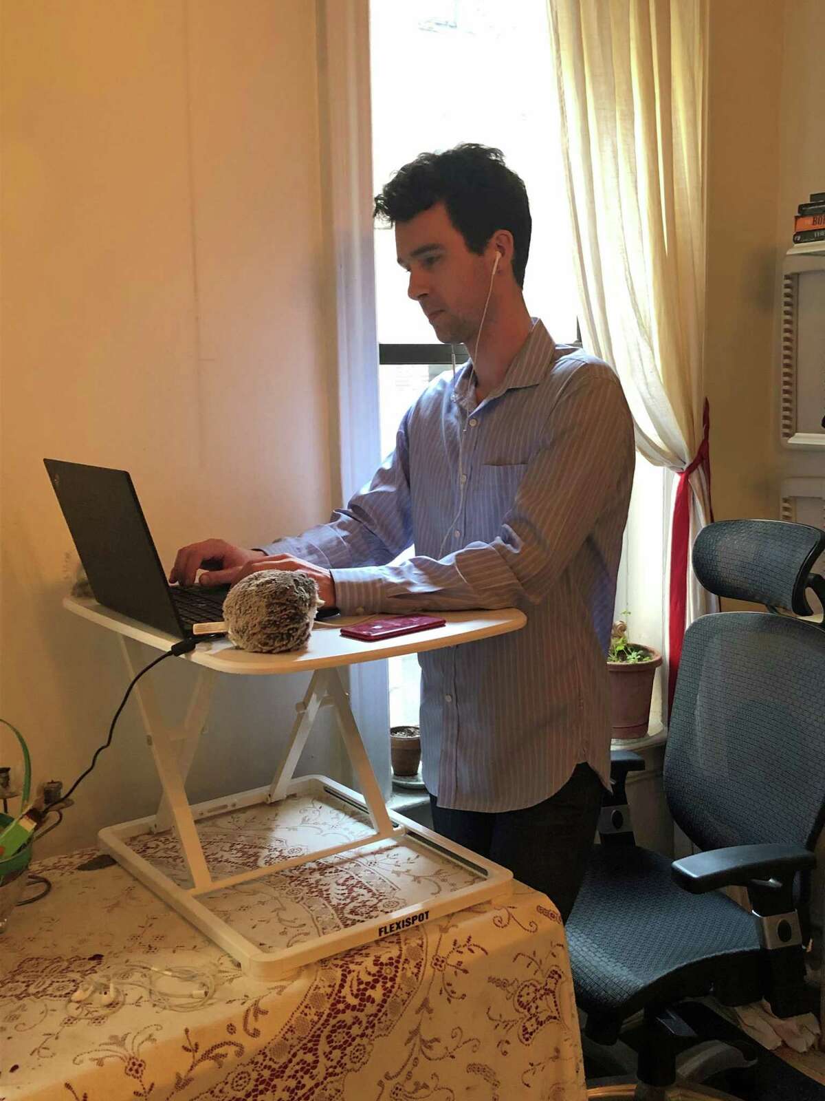 Charles-Edouard Catherine, associate director of special projects at the National Organization on Disability, is pictured at his home office in Brooklyn, N.Y. Catherine, who is blind, is using JAWS, a computer screen reader program for Microsoft Windows that allows blind and visually impaired people to read the screen, either with a text-to-speech output or by a refreshable Braille display. He said workers with disabilities are disproportionately affected by recessions.