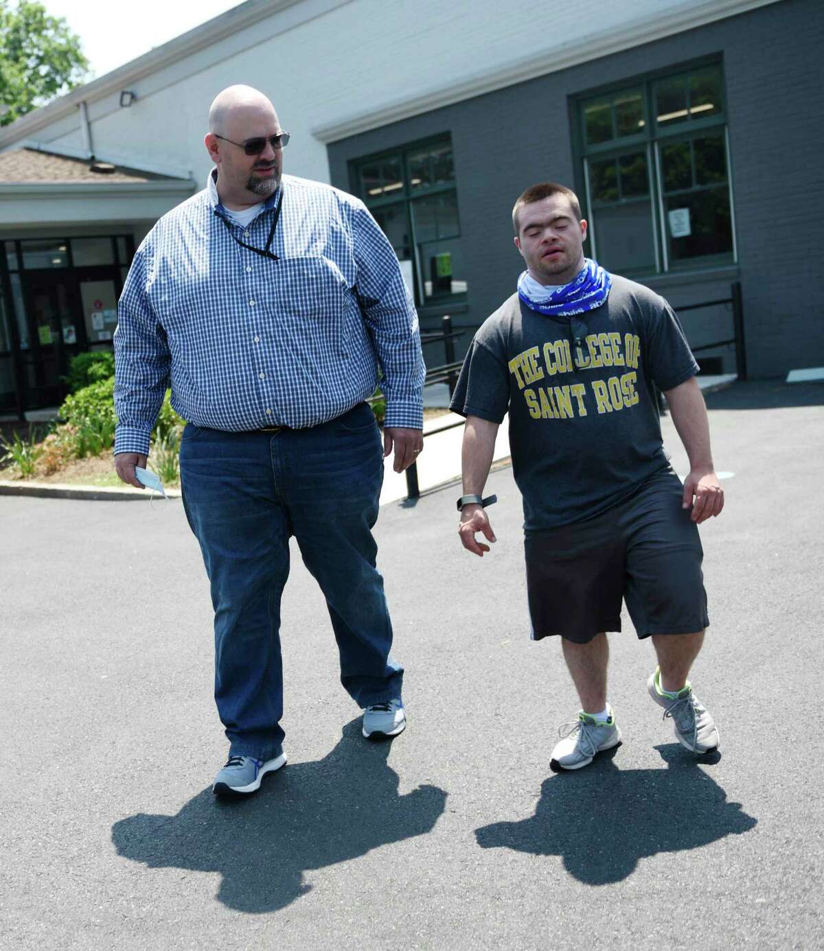Abilis Director of Competitive Employment Matthew Miceli, left, and Abilis client Joe Lupinacci chat outside Abilis in the Glenville section of Greenwich, Conn. Wednesday, May 26, 2021. COVID-19 affected the employment rate for people with disabilities more so than those without disabilities. Lupinacci was furloughed from his job as an aquatics assistant at the New Canaan YMCA during the pandemic.