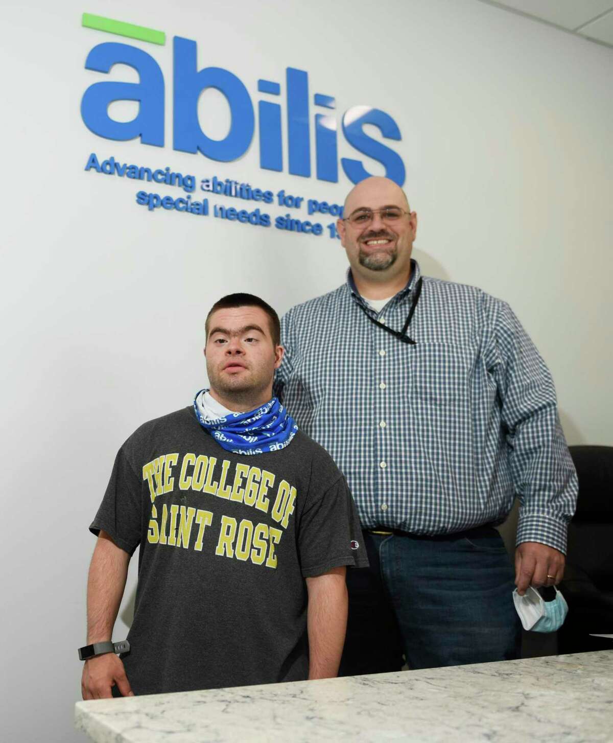 Abilis client Joe Lupinacci, left, and Abilis Director of Competitive Employment Matthew Miceli pose together at Abilis in the Glenville section of Greenwich, Conn. Wednesday, May 26, 2021. COVID-19 affected the employment rate for people with disabilities more so than those without disabilities. Lupinacci was furloughed from his job as an aquatics assistant at the New Canaan YMCA during the pandemic.