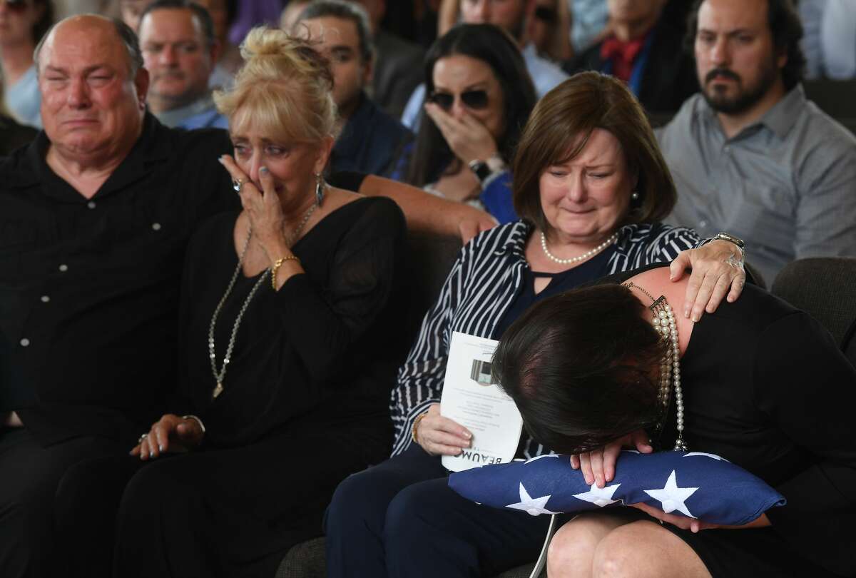 Jennifer Pate is consoled by her mother Martha Brown Pate after being presented with the flag covering her father's casket during military honors at the funeral service for W.L. Pate at One City Church Friday. Photo made Friday, June 25, 2021 Kim Brent/The Enterprise