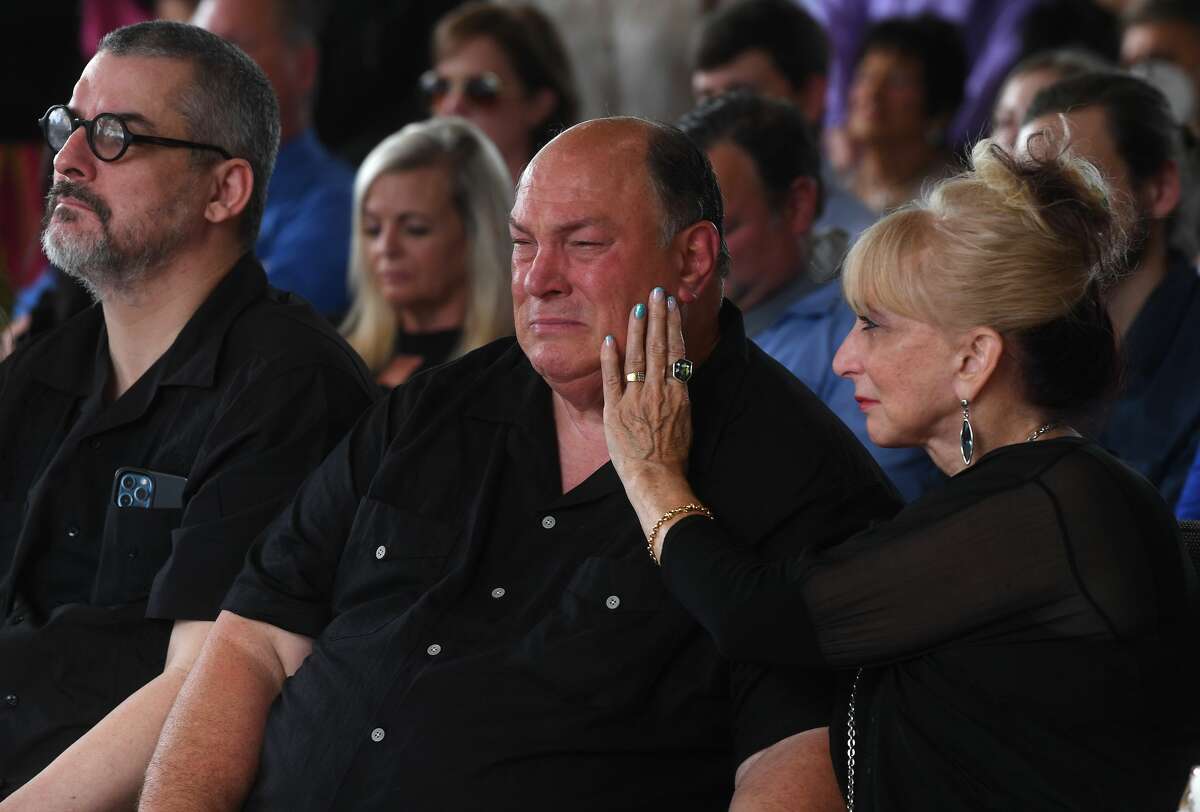 Sandy Pate consoles her husband Robert following a 21-gun salute and other military honors for brother W.L. Pate at One City Church Friday. Photo made Friday, June 25, 2021 Kim Brent/The Enterprise