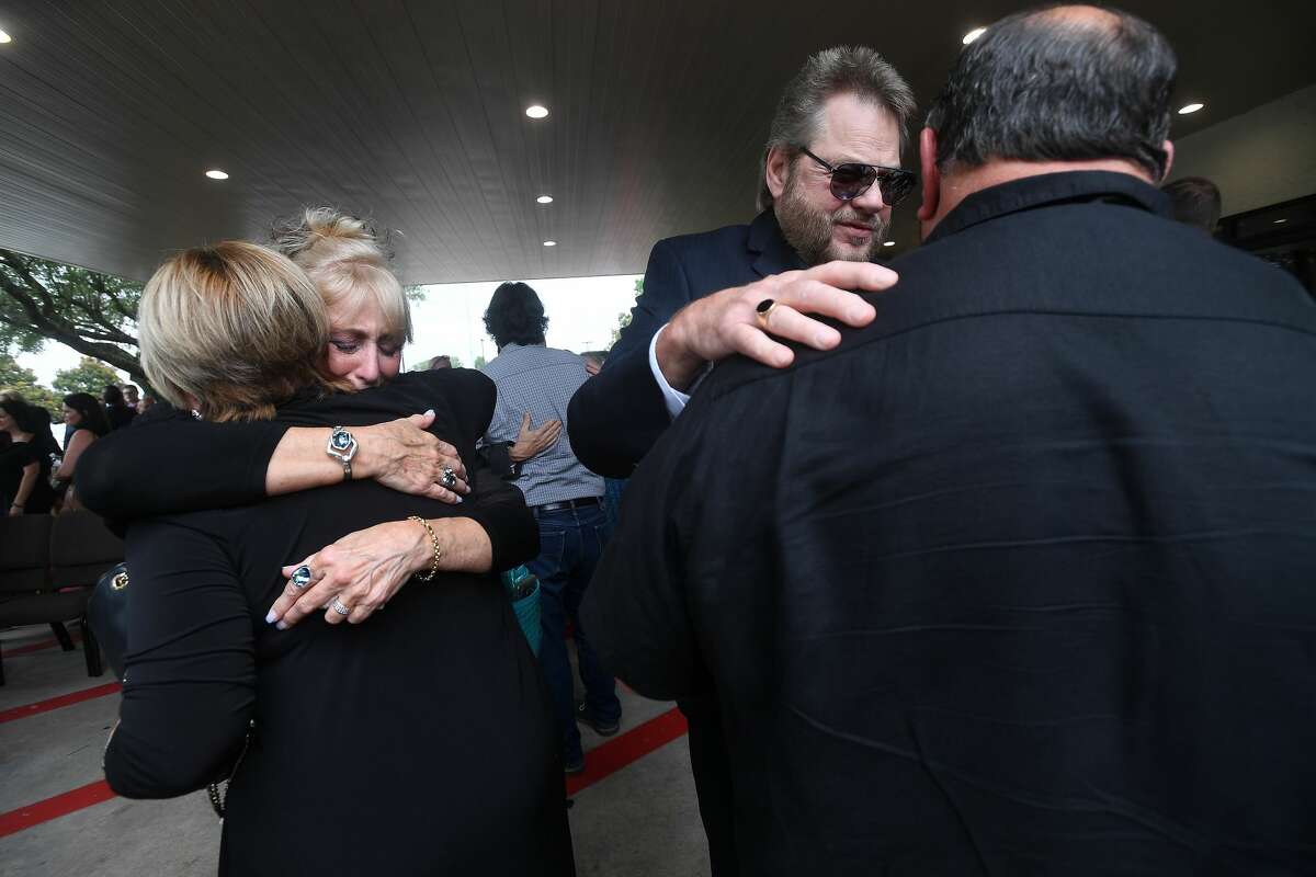 Sandy Pate hugs Becky Ames as others gather to offer their condolences to the family during the funeral service for W.L. Pate at One City Church Friday. Photo made Friday, June 25, 2021 Kim Brent/The Enterprise