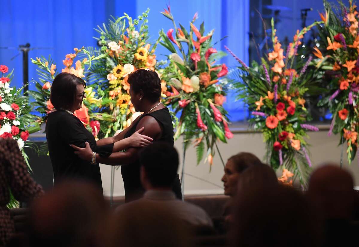 Jennifer Pate (left) receives greetings and words of condolence during the funeral service for her father W.L. Pate at One City Church Friday. Photo made Friday, June 25, 2021 Kim Brent/The Enterprise