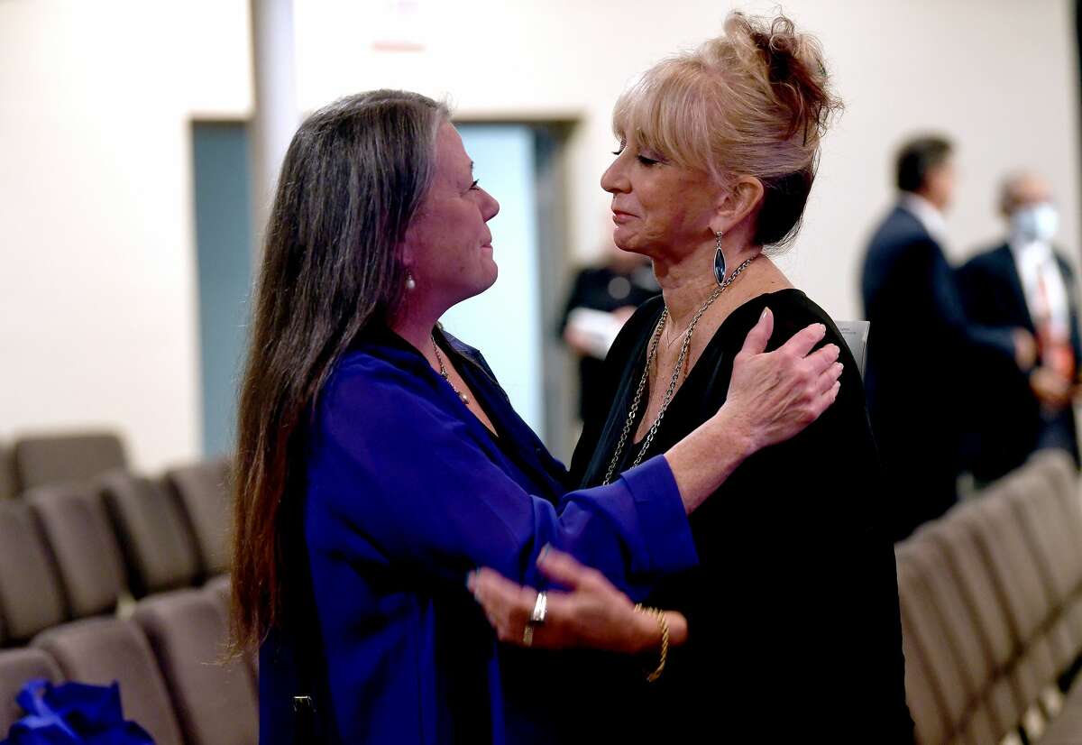 Sandy Pate (right) gets support as friends and family arrive to the funeral service for W.L. Pate at One City Church Friday. Photo made Friday, June 25, 2021 Kim Brent/The Enterprise