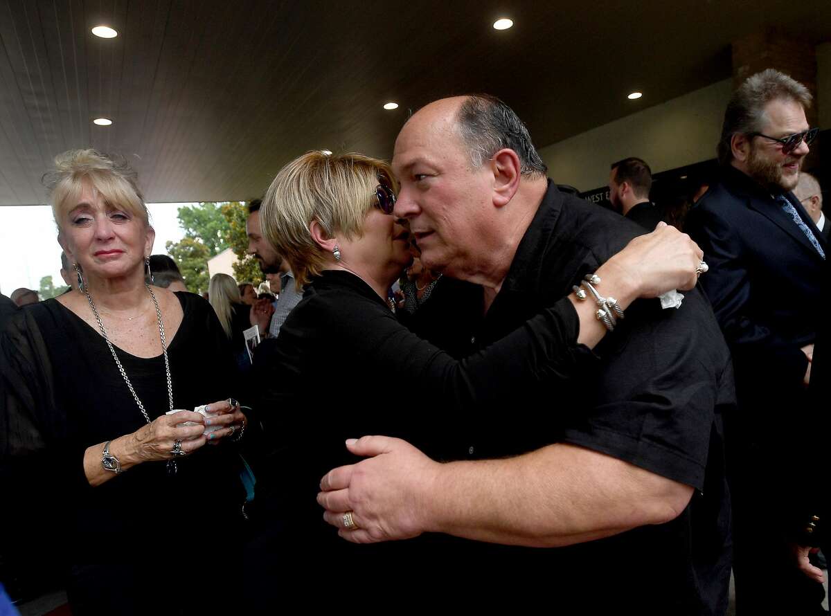 Robert Pate gets a hug of condolence from Becky Ames as his wife Sandy stands nearby during the funeral service for W.L. Pate at One City Church Friday. Photo made Friday, June 25, 2021 Kim Brent/The Enterprise
