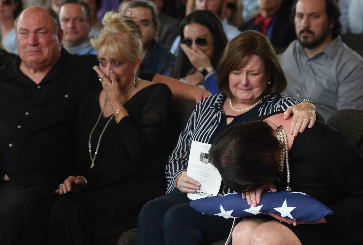 Jennifer Pate is consoled by her mother Martha Brown Pate after being presented with the flag covering her father's casket during military honors at the funeral service for W.L. Pate at One City Church Friday. Photo made Friday, June 25, 2021 Kim Brent/The Enterprise