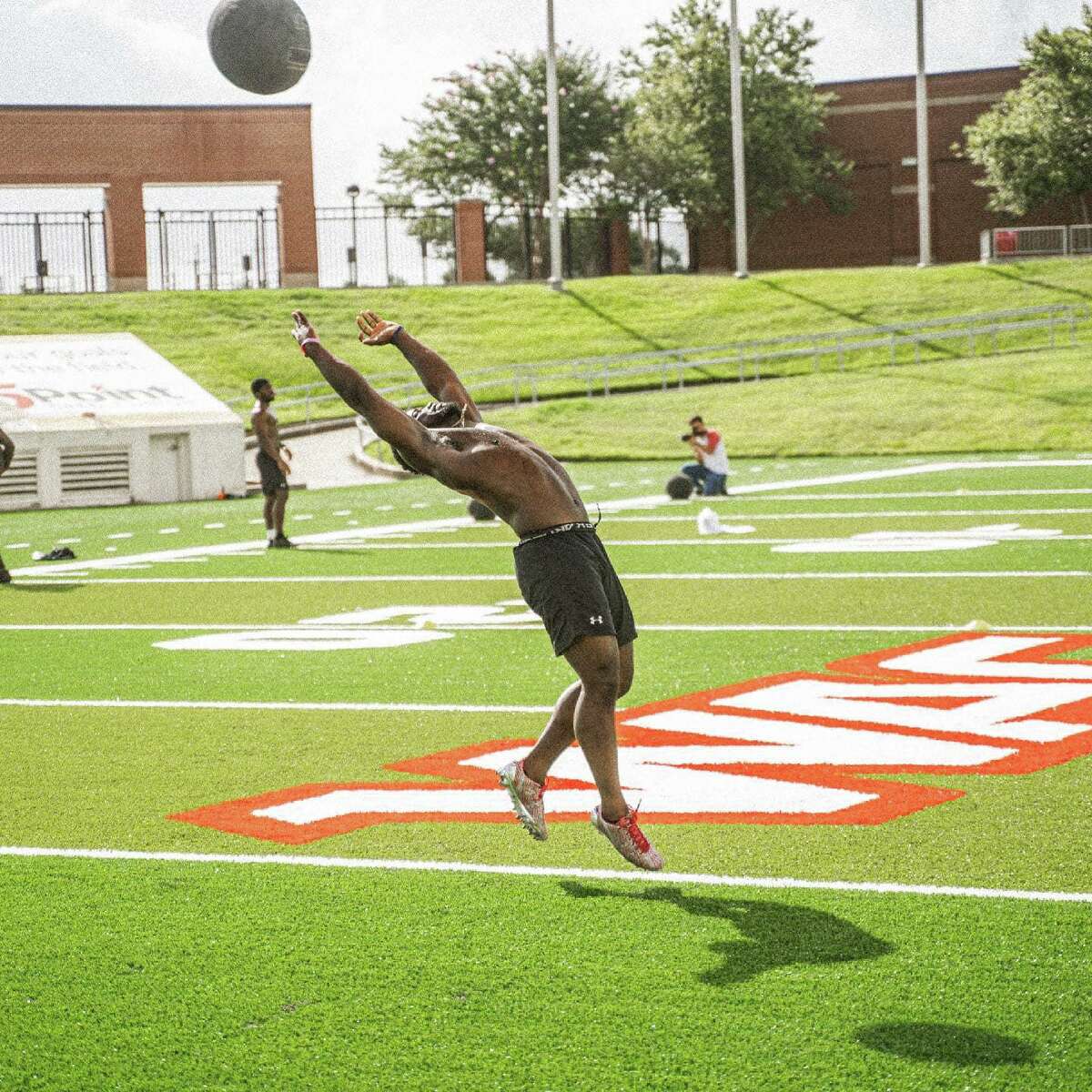 A Lamar football player trains on the new turf surface at Provost Umphrey Stadium, which includes the new Western Athletic Conference logo seen in the background.