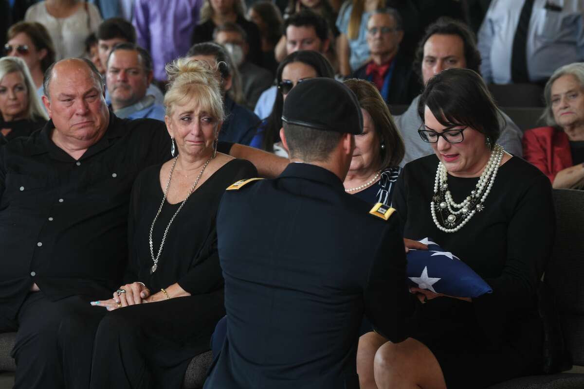 Jennifer Pate is presented with her father's flag during the funeral service for W.L. Pate at One City Church Friday. Photo made Friday, June 25, 2021 Kim Brent/The Enterprise
