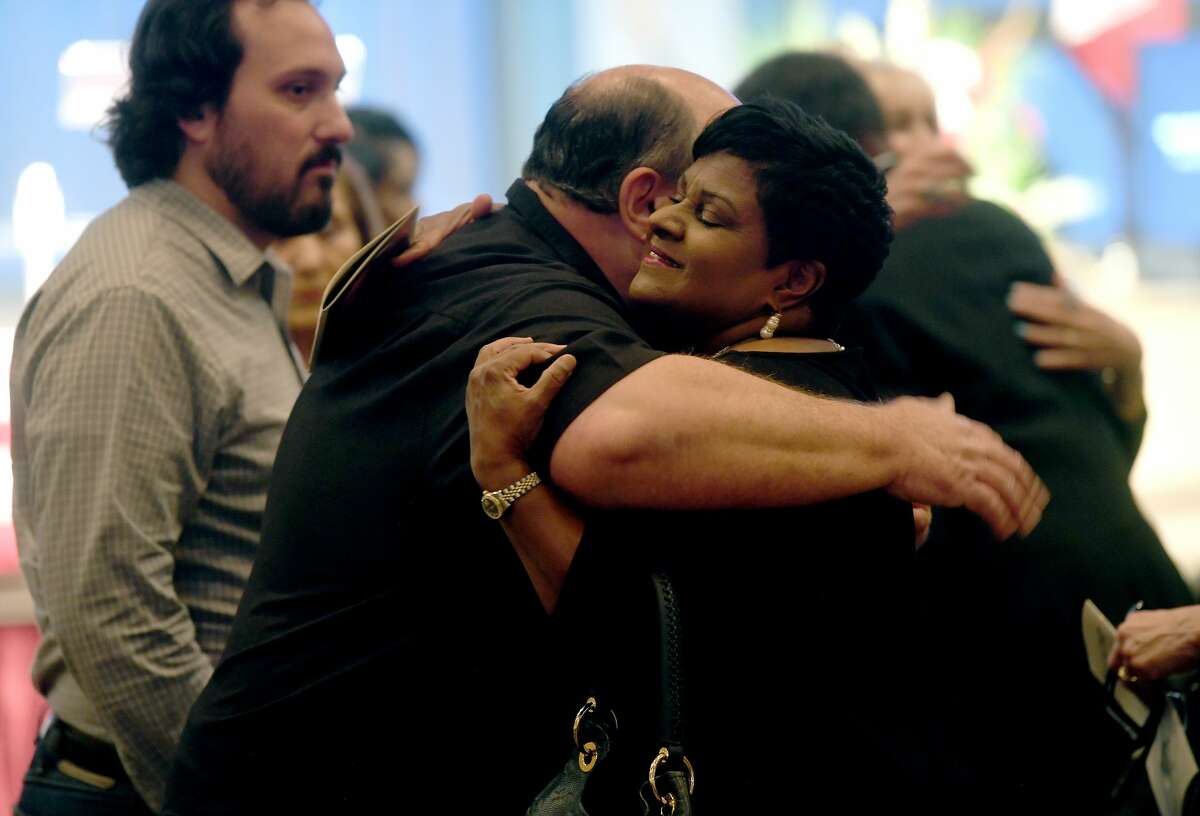 Mayor-elect Robin Mouton hugs Robert Pate as she greets the family during the funeral service for W.L. Pate at One City Church Friday. Photo made Friday, June 25, 2021 Kim Brent/The Enterprise