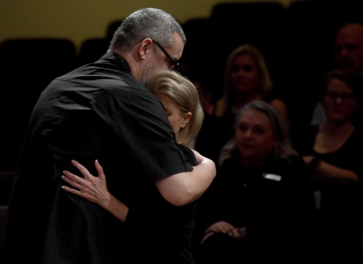 Sherrene Danks-Cook hugs Rafael Ruiz after he shares memories with the gathering assembled during the funeral service for W.L. Pate at One City Church Friday. Photo made Friday, June 25, 2021 Kim Brent/The Enterprise
