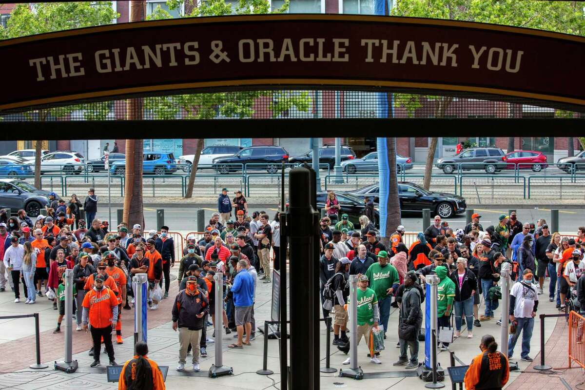 Fans line up to enter Oracle Park for the MLB game between the San Francisco Giants and Oakland Athletics, Friday, June 25, 2021, in San Francisco, Calif. It’s the first game at the park without a capacity limit since the start of the coronavirus pandemic limited or banned spectators at sports venues.