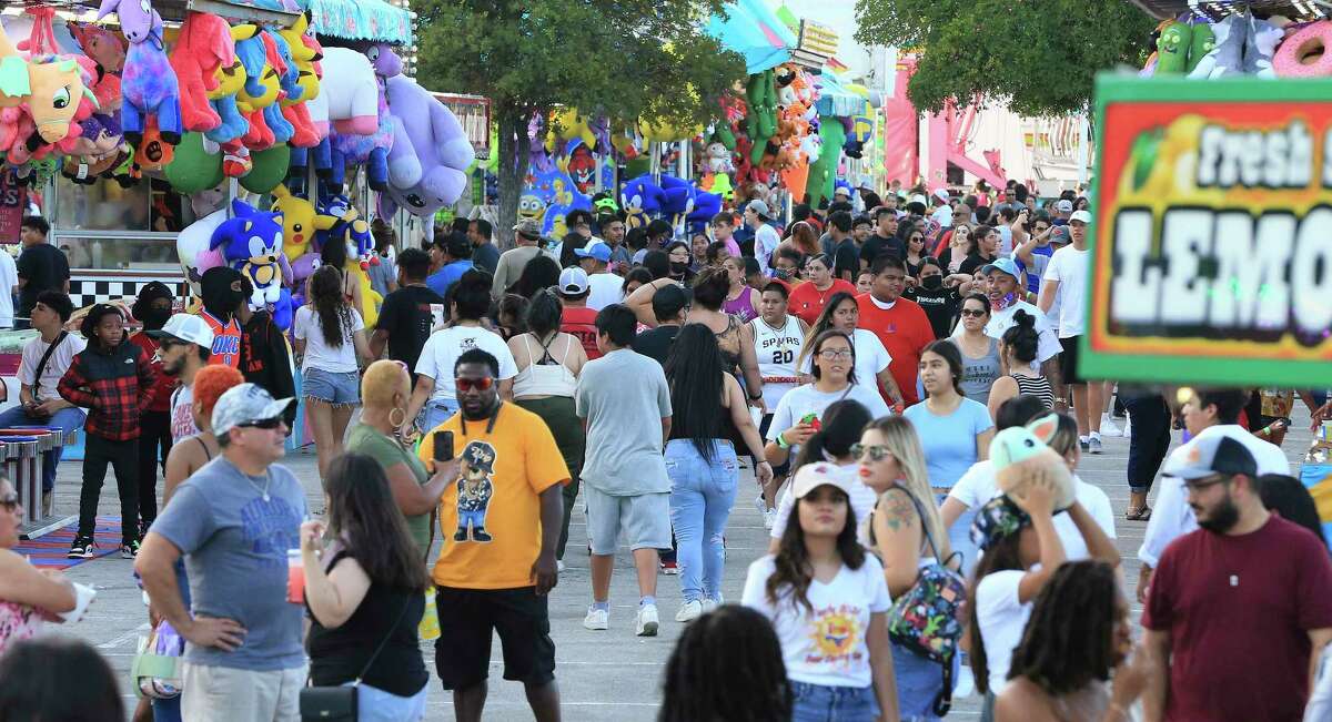 A crowd walks the midway at Fiesta Carnival at San Antonio’s Alamodome in June. Bexar County grew by almost 300,000 people in the past decade.