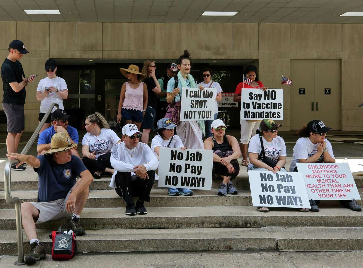 People gathered outside Houston Methodist to protest the hospital's mandate that all staff must be vaccinated against COVID-19 or be terminated, on Saturday, June 26, 2021, in Houston.