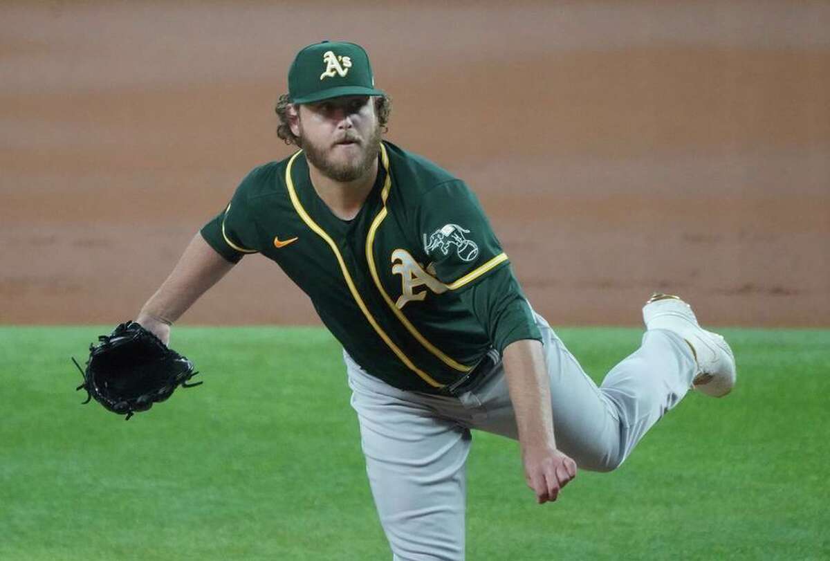 Oakland Athletics starting pitcher Cole Irvin throws against the Texas Rangers in a baseball game Tuesday, June 22, 2021, in Arlington, Texas. (AP Photo/Louis DeLuca)