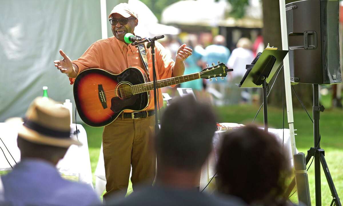 Musician and storyteller Neddy Smith spins a yarn during The Norwalk Art Festival Saturday, June 26, 2021, at Mathews Park in Norwalk, Conn. The festival which continues Sunday features the works of 100 juried artists exhibiting a wide variety of media including, photography, drawing, ceramics, jewelry, painting, mixed media, printmaking, fiber, metal sculpture and glass. The Center for Contemporary Printmaking, Stepping Stones Museum, Mathews Mansion Museum and The Norwalk Parks Department, sponsored the festival.