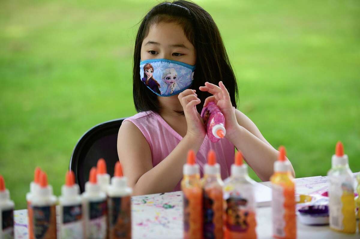 Zoe Wong, 8, makes art at the Artivity Tent sponsored by Jerry's Artarama during the Norwalk Art Festival.