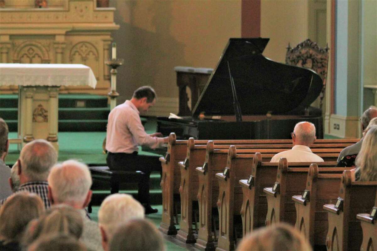 Classical pianist Nakita Sokolov performs during a free concert at Guardian Angels Church in Manistee on Saturday. The event was hosted by the Guardian Angels Historic Preservation Project and all donations will go toward the current phase of building restoration work at the church. (Kyle Kotecki/News Advocate)