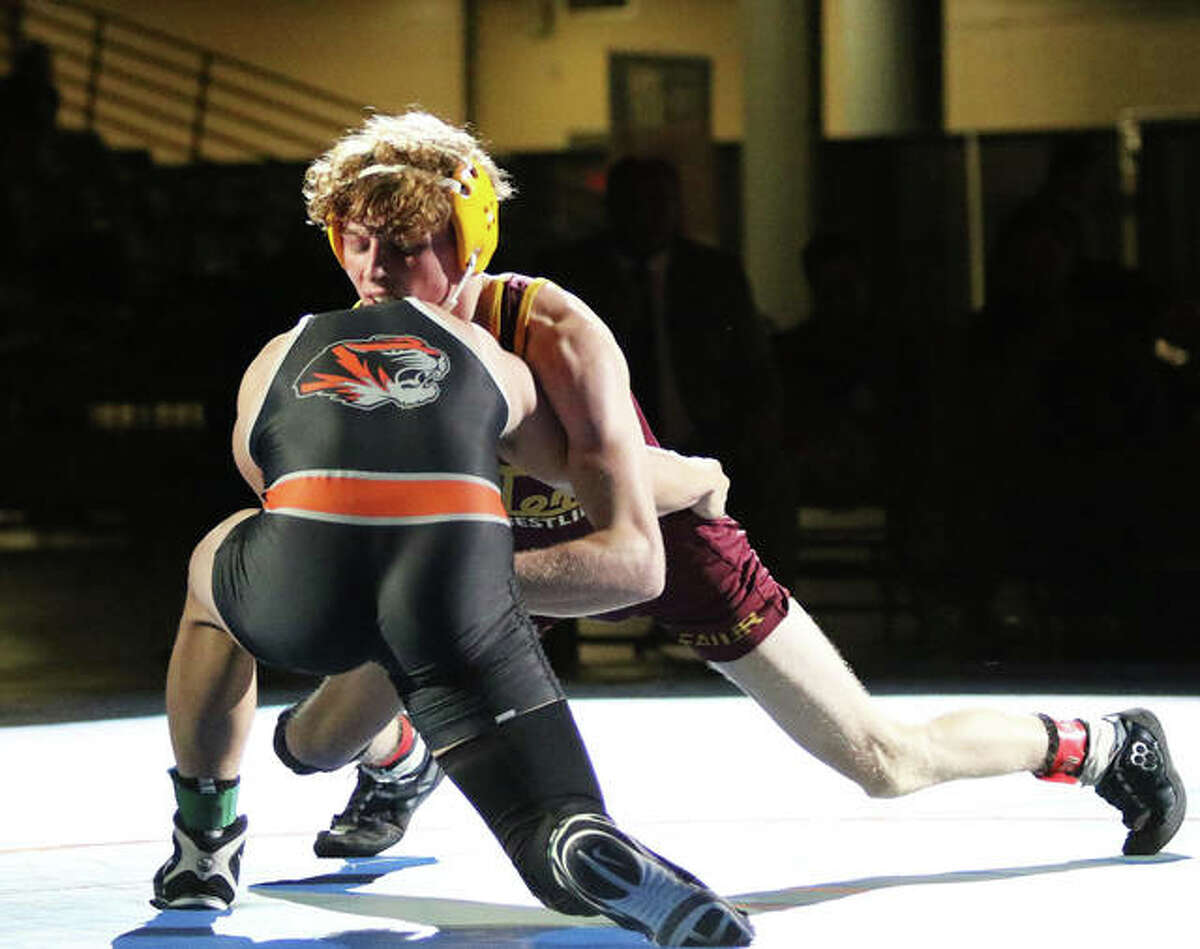 EA-WR junior Jason Shaw (right) tries to gain an advantage against Illini Bluffs’ Paul Ishikawa in the 126-pound championship match at the IWCOA Class 1A state wrestling meet Thursday in Bank of Springfield Center in Springfield. Shaw lost a 3-1 decision in overtime to finish his season at 27-2.