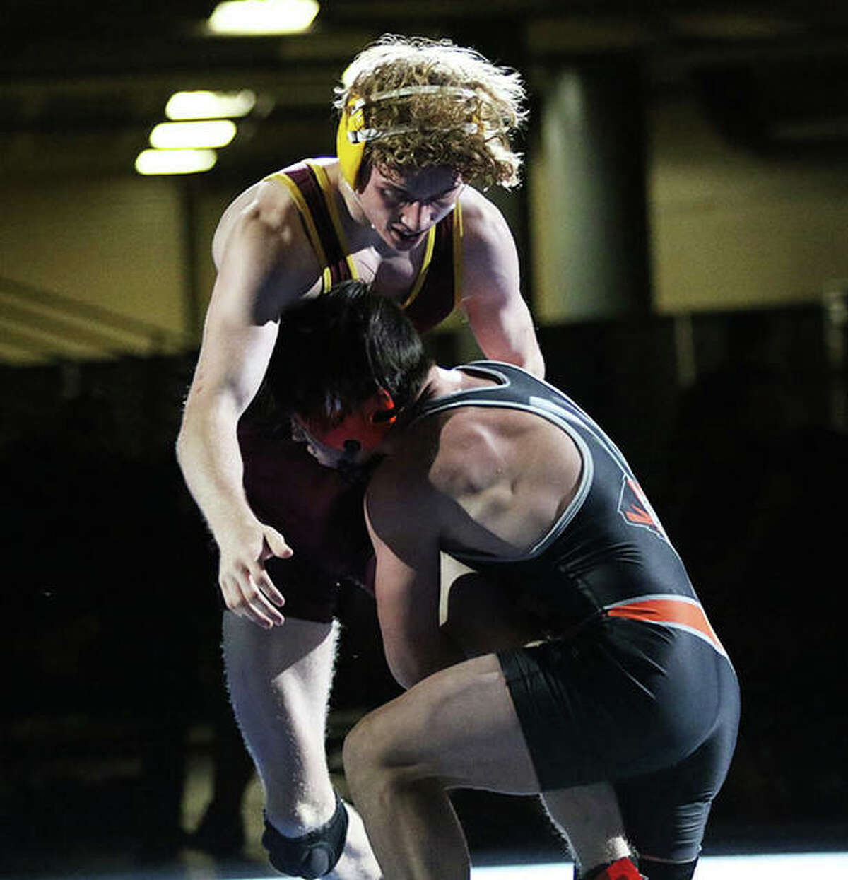 Illini Bluffs’ Paul Ishikawa wraps up the left leg of EA-WR’s Jason Shaw (back) and takes him off the mat for a takedown in the final seconds of overtime to win their 126-pound title match Thursday in the Class 1A state meet in Springfield.