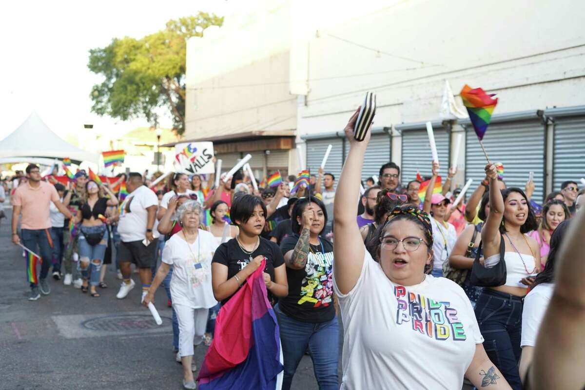 Large crowd cheers and celebrate as they walk in the Pride Parade on Iturbide Street on June 26, 2021.