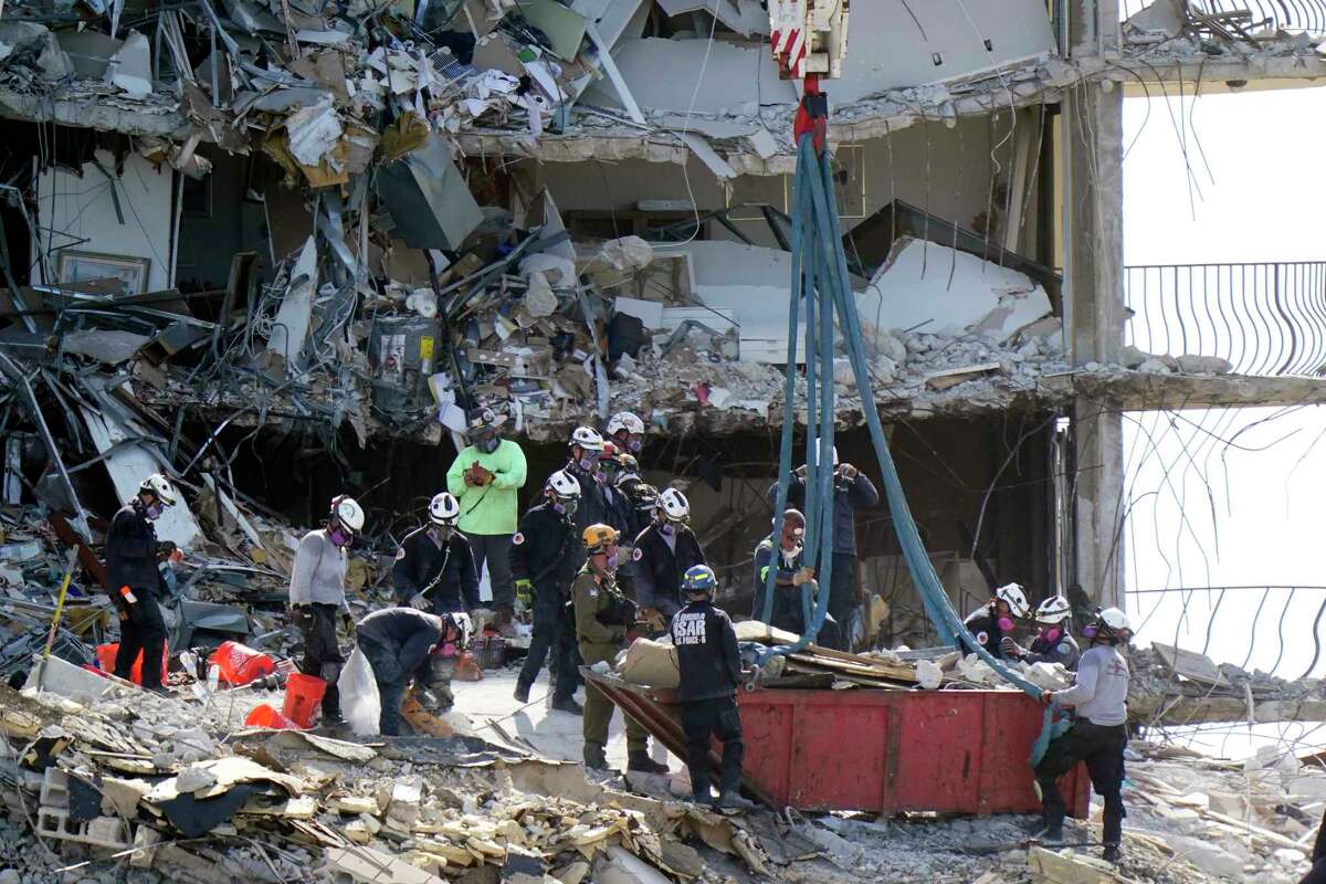 Crews work in the rubble at the Champlain Towers South Condo, Sunday, June 27, 2021, in Surfside, Fla. Many people were still unaccounted for after Thursday's fatal collapse.