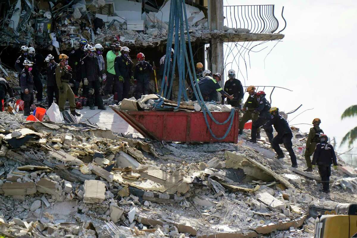 A new group of rescue workers arrive as crews work in the rubble at the Champlain Towers South Condo, Sunday, June 27, 2021, in Surfside, Fla. Many people were still unaccounted for after Thursday's fatal collapse.