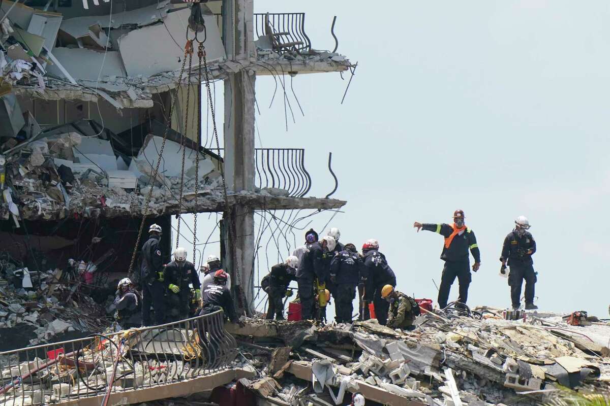 Crews work in the rubble at the Champlain Towers South Condo, Sunday, June 27, 2021, in Surfside, Fla. Many people are still unaccounted for after Thursday's fatal collapse.
