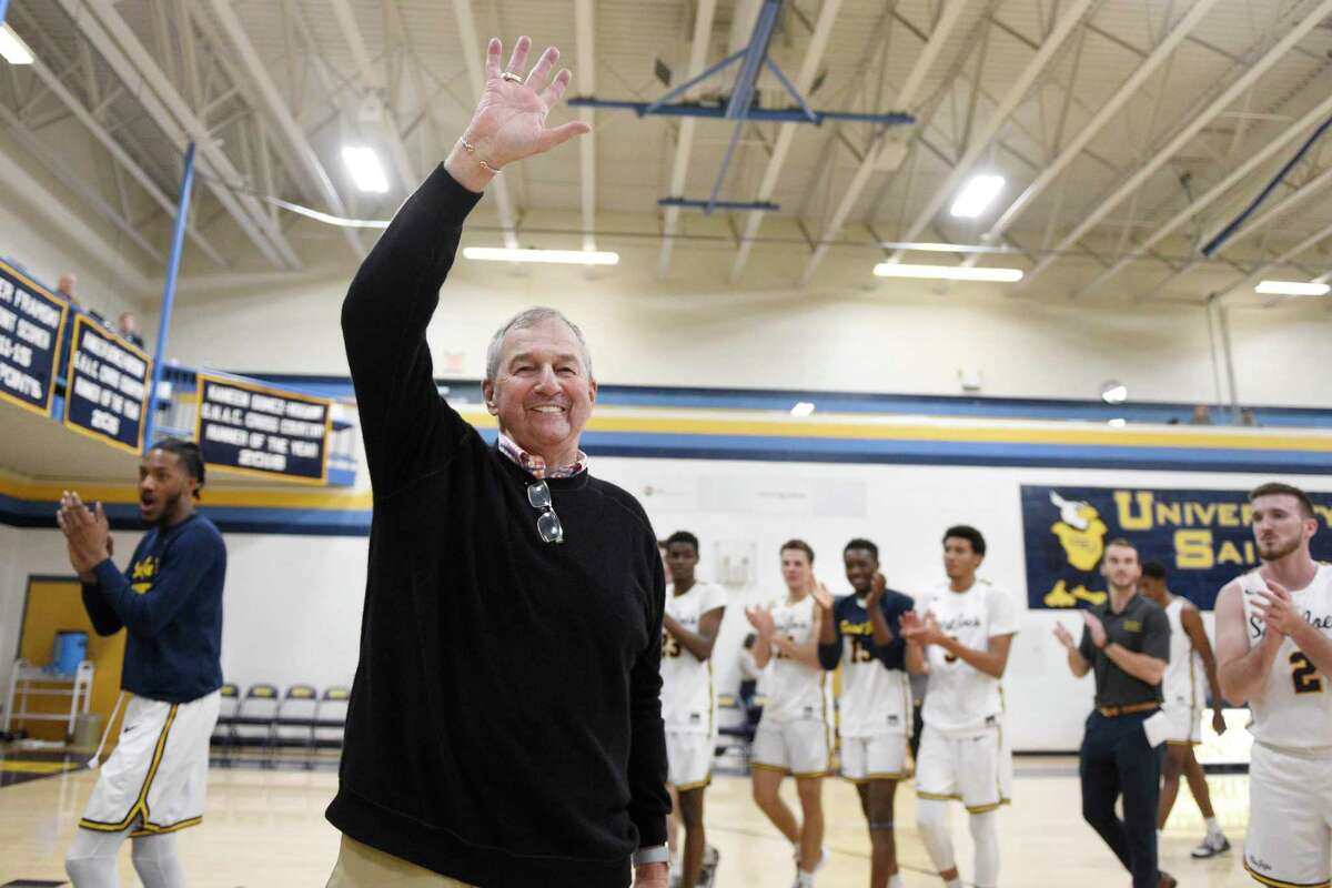 Saint Joseph coach Jim Calhoun smiles and waves to fans after the team's win in an NCAA college basketball game Friday, Jan. 10, 2020, in West Hartford, Conn. Now coaching Division III basketball with the same fire he stalked the sidelines at UConn, Calhoun reached his 900th win as a college coach. (AP Photo/Jessica Hill)