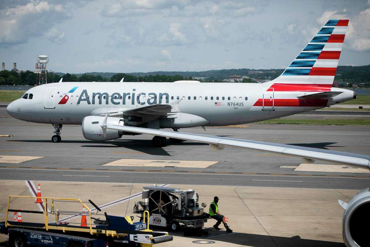 This June 2, 2021 photo shows an American Airlines aircraft at Ronald Reagan Washington National Airport in Arlington, Va. American Airlines is cutting flights to protect its network from getting overloaded as summer travel season arrives. American scrubbed more than 130 flights by Tuesday, June 22 according to tracking service FlightAware.