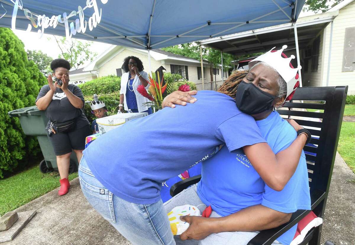 Diverna Abatte gets a hug and visit from Toni Hayes, one of her foster children, during a drive-by parade and celebration at her home to honor her 42 years serving as a foster parent. Abatte fostered with Buckner since 2002, but began her lifelong ministry of fostering with Jefferson County's Child Protective Services in 1979. In all, roughly 175 children have crossed her doorstep throughout the years, many. of which she has kept up with over the years. Photo made Wednesday, June 23, 2021 Kim Brent/The Enterprise