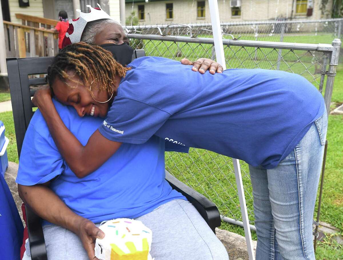 Diverna Abatte gets a hug and visit from Toni Hayes, one of her foster children, during a drive-by parade and celebration at her home to honor her 42 years serving as a foster parent. Abatte fostered with Buckner since 2002, but began her lifelong ministry of fostering with Jefferson County's Child Protective Services in 1979. In all, roughly 175 children have crossed her doorstep throughout the years, many. of which she has kept up with over the years. Photo made Wednesday, June 23, 2021 Kim Brent/The Enterprise