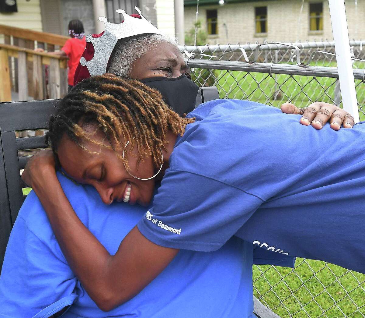 Diverna Abatte gets a hug and visit from Toni Hayes, one of her foster children, during a drive-by parade and celebration at her home to honor her 42 years serving as a foster parent. Abatte fostered with Buckner since 2002, but began her lifelong ministry of fostering with Jefferson County's Child Protective Services in 1979. In all, roughly 175 children have crossed her doorstep throughout the years, many. of which she has kept up with over the years. Photo made Wednesday, June 23, 2021 Kim Brent/The Enterprise