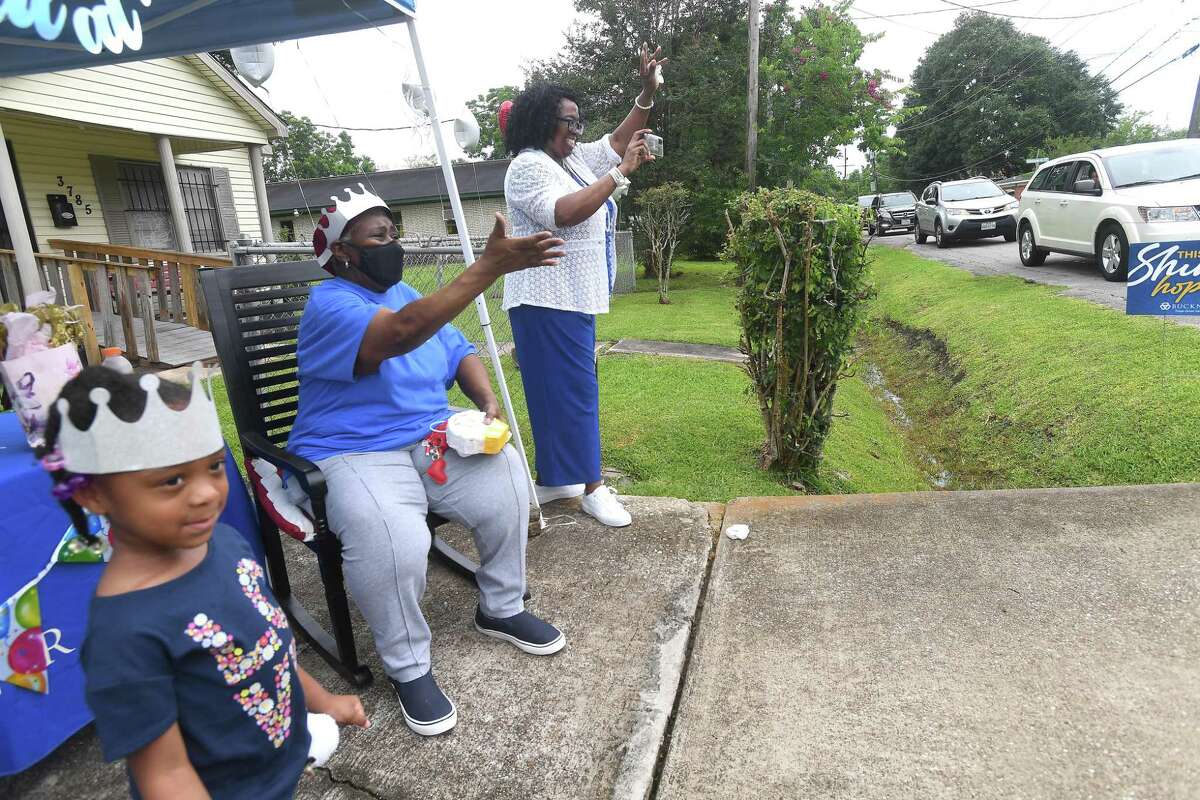 Diverna Abatte and Buckner's Annie Flemon wave during a drive-by parade and celebration at her home to honor her 42 years serving as a foster parent. Abatte fostered with Buckner since 2002, but began her lifelong ministry of fostering with Jefferson County's Child Protective Services in 1979. In all, roughly 175 children have crossed her doorstep throughout the years, many. of which she has kept up with over the years. Photo made Wednesday, June 23, 2021 Kim Brent/The Enterprise