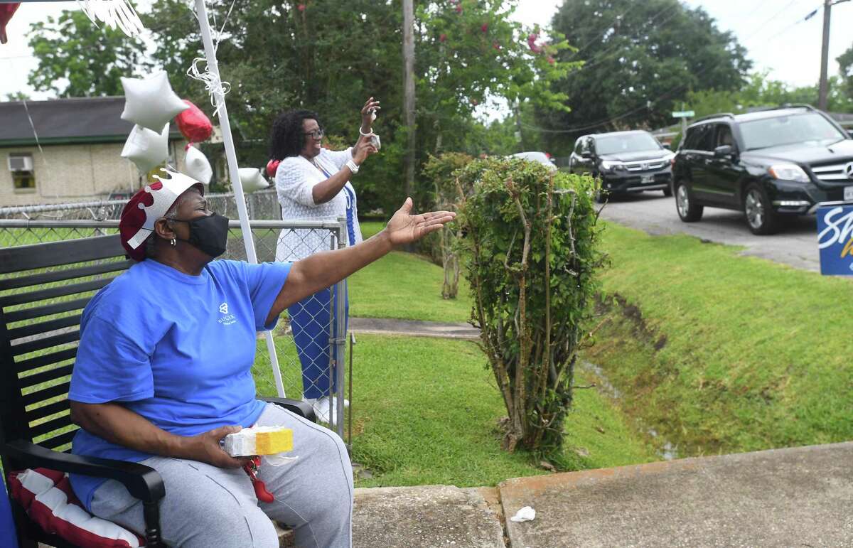 Diverna Abatte and Buckner's Annie Flemon wave during a drive-by parade and celebration at her home to honor her 42 years serving as a foster parent. Abatte fostered with Buckner since 2002, but began her lifelong ministry of fostering with Jefferson County's Child Protective Services in 1979. In all, roughly 175 children have crossed her doorstep throughout the years, many. of which she has kept up with over the years. Photo made Wednesday, June 23, 2021 Kim Brent/The Enterprise