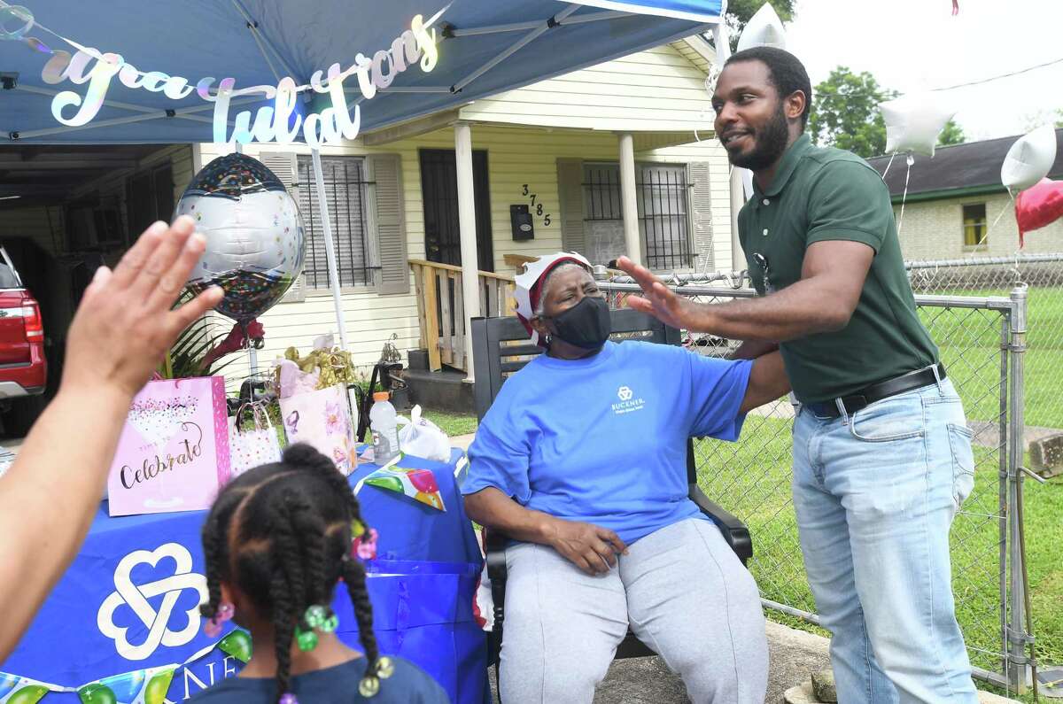 Diverna Abatte greets former foster son James Tyler during a drive-by parade and celebration at her home to honor her 42 years serving as a foster parent. Abatte fostered with Buckner since 2002, but began her lifelong ministry of fostering with Jefferson County's Child Protective Services in 1979. In all, roughly 175 children have crossed her doorstep throughout the years, many. of which she has kept up with over the years. Photo made Wednesday, June 23, 2021 Kim Brent/The Enterprise