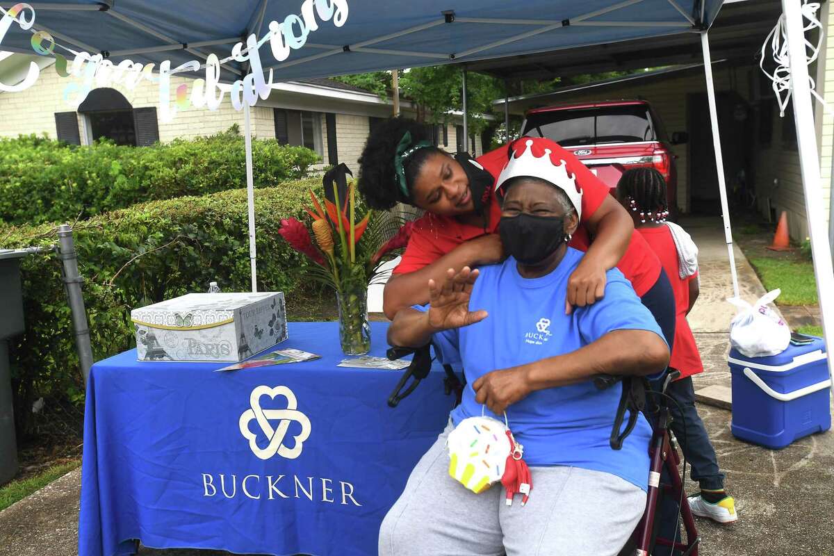 Marinette Landry Parkerson adjusts a crown for Diverna Abatte during a drive-by parade and celebration at her home to honor her 42 years serving as a foster parent. Abatte fostered with Buckner since 2002, but began her lifelong ministry of fostering with Jefferson County's Child Protective Services in 1979. In all, roughly 175 children have crossed her doorstep throughout the years, many. of which she has kept up with over the years. Photo made Wednesday, June 23, 2021 Kim Brent/The Enterprise