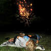 In this 2020 file photo, citizens lay on a blanket as they watch the fireworks at Edwardsville High School.