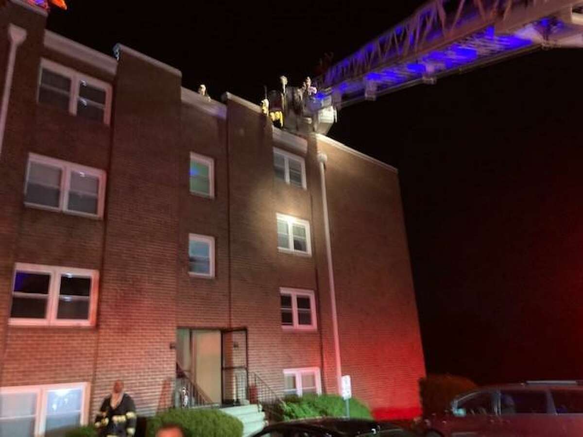 Firefighters respond to Chestnut Hill apartments at 925 Mix Ave. in Hamden June 26, 2021, for a fire that reportedly started in the void space below the roof. Responders had to rip out ceilings to get access.