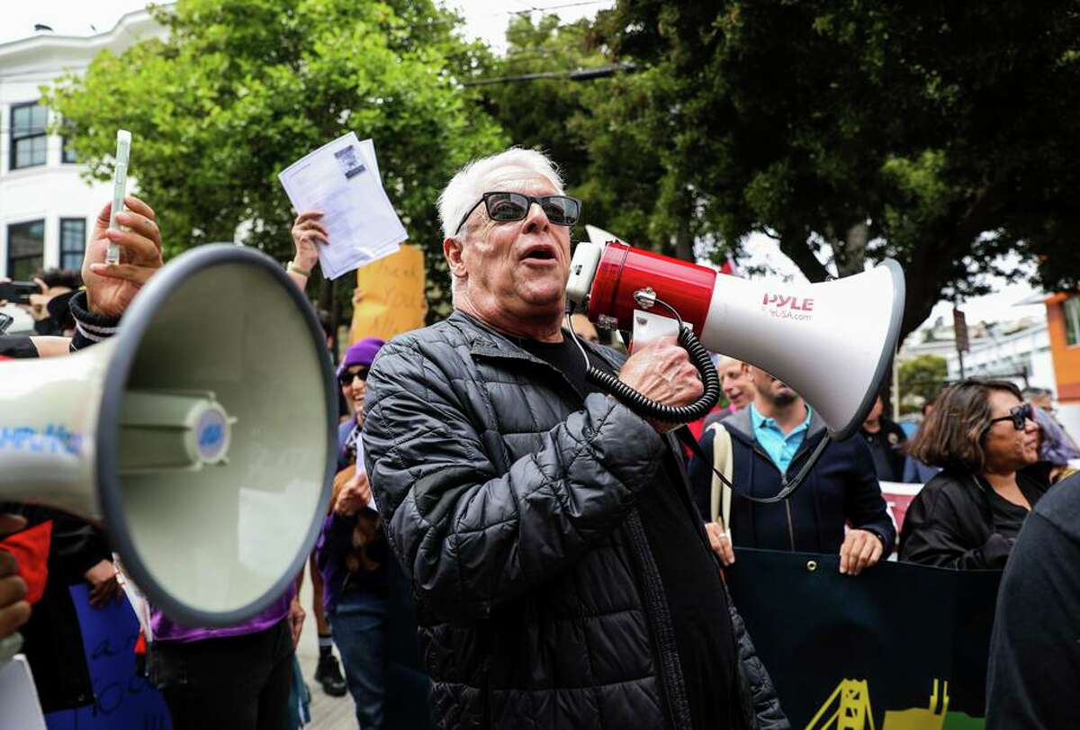 Cleve Jones uses a bullhorn to call out to Allan Baird, who gave Milk his own bullhorn, after leading a march honoring Baird for his commitment to labor and to the LGBTQ community.