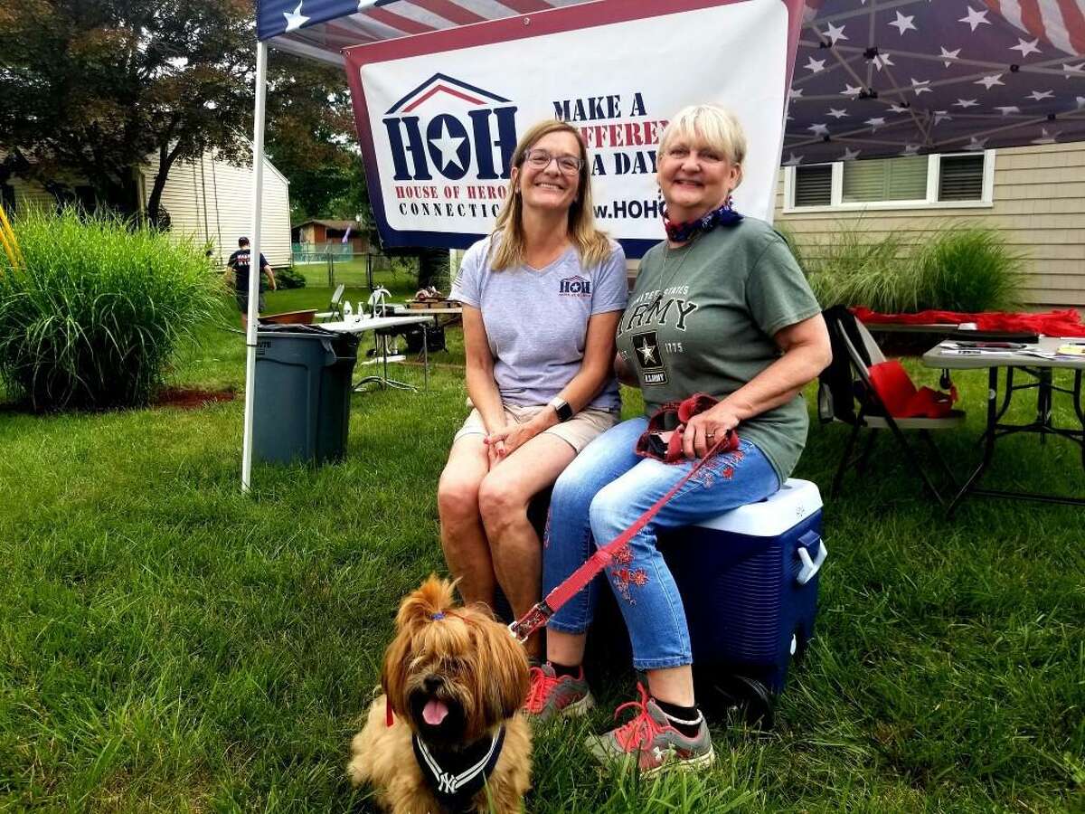 Carol May of House of Heroes Connecticut, left, and homeowner Robbin Wyatt Ford on Saturday.