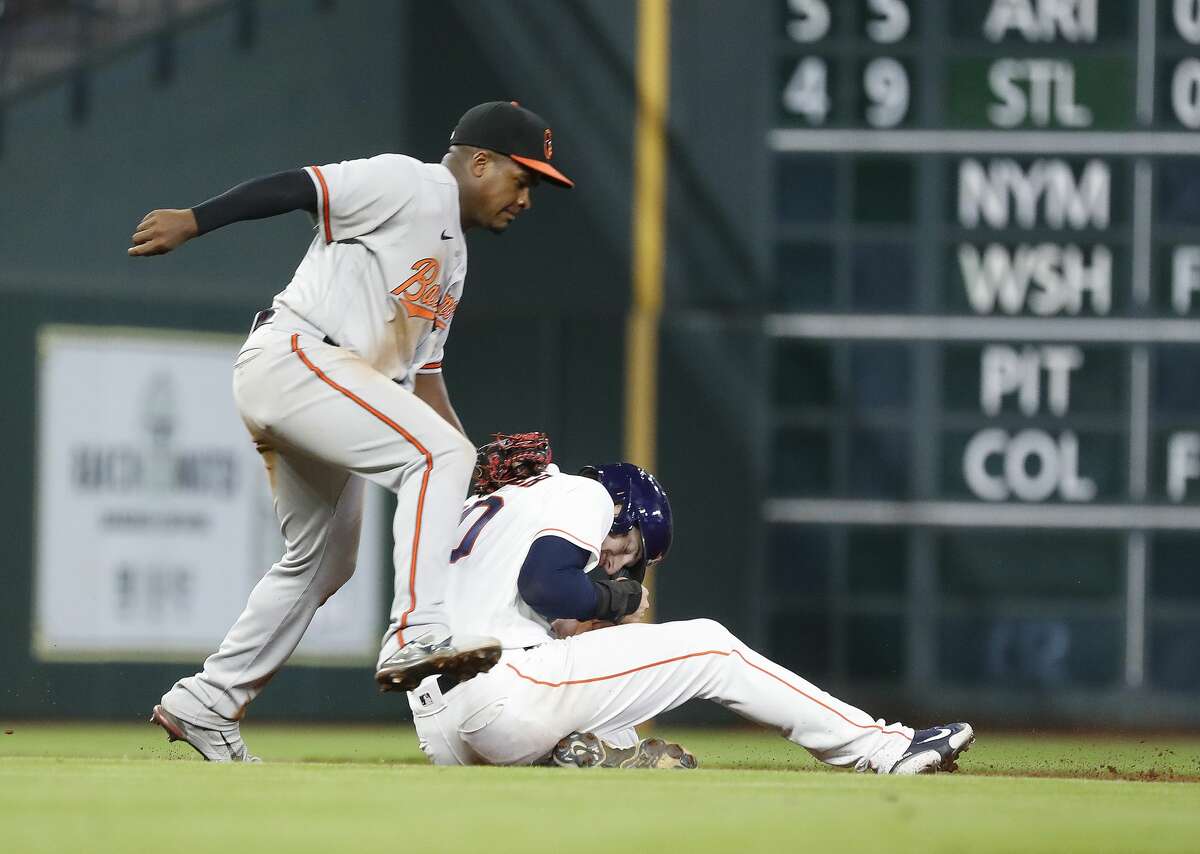 Houston Astros Kyle Tucker (30) gets caught in a rundown by Baltimore Orioles third baseman Domingo Leyba (75) during the sixth inning of an MLB baseball game at Minute Maid Park, Monday, June 28, 2021, in Houston.