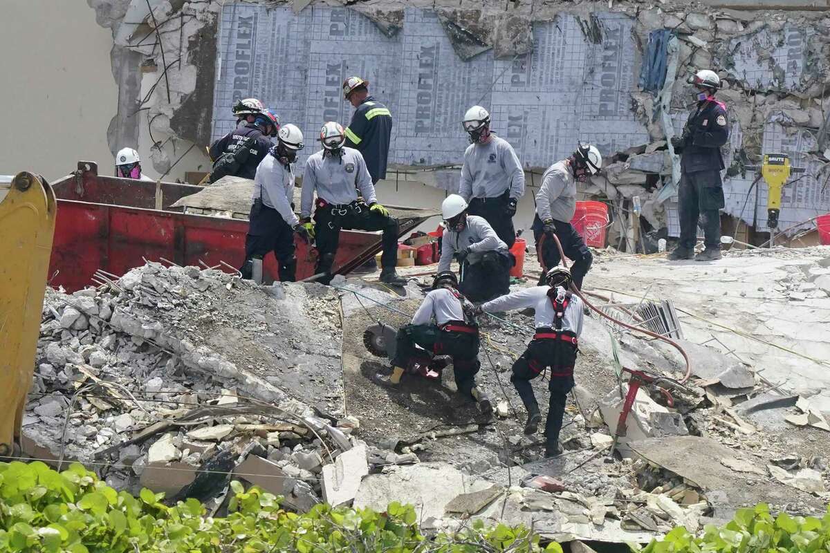 Workers cut a large slab of concrete at the Champlain Towers South condo, Monday, June 28, 2021, in Surfside, Fla. Many people were still unaccounted for after Thursday's fatal collapse.